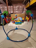 Full view of jumper showing frame, seat and toys