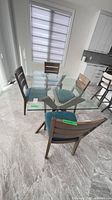 Dining table area showing all four chairs around glass table