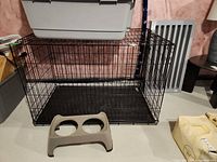 Overall view of dog crate and bowl stand