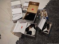 Group of open shoe boxes showing multiple pairs