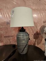 Full view of ceramic lamp with shade