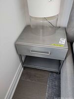 Front view of nightstand beside bed