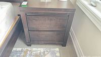 Front view of dark brown two-drawer nightstand