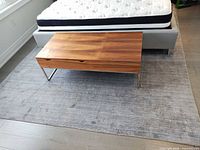 Rug positioned under bed and coffee table showing full surface