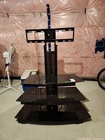 Front view showing three glass shelves and mounting bracket