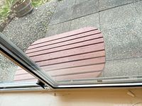 Slatted wood side table top viewed through window