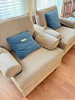 Pair of beige Barrymore armchairs with blue pillows