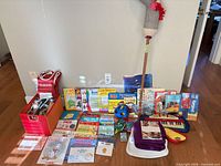 Full lot overview showing books, toys, keyboard, shape sorter and hobby horse