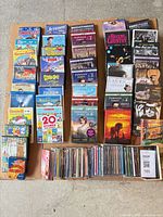 Full lot overview showing DVDs and CDs arranged on cardboard