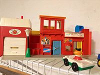 Overall view of firehouse side of playset on shelf