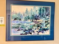 Front view of framed watercolor landscape painting under glass