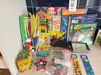 Full lot laid out: crayons, sketchbooks, pipe cleaners, pom poms, stickers, patches, crafts