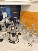 Coffee grinder, cupcake racks, juicer parts on countertop