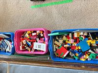 Three tubs filled with assorted LEGO pieces