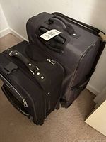 Two softside suitcases stacked showing overall form and fabric
