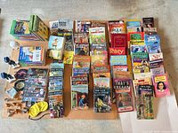 Full lot overview with books laid out, figurines and accessories visible