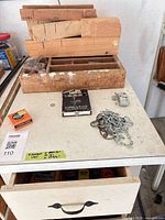 Cabinet top with wooden box, chain, electrical box, cabinet front