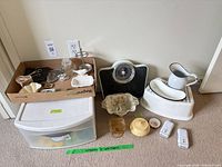 Full lot overview with Sterilite drawers, enamelware pitcher and basin on step stool, Starfit scale and various dishes