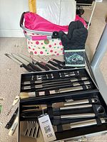 Overall lot showing picnic basket, oven mitt, knives and BBQ tool case
