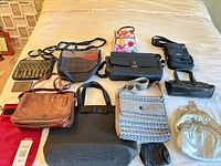 Overview of all handbags and wristlets laid on bed