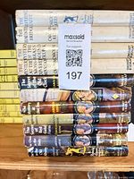 Spines of dust-jacketed Nancy Drew books alongside yellow spine volumes