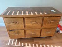 Front view showing six drawers and brown tile top