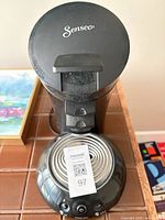 Top view showing Senseo branding, drip tray, and QR tag