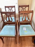 Front view of all four lyre-back dining chairs