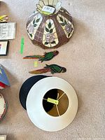 Group shot showing stained glass dome shade, two parrot pieces, white fabric shade