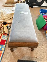 Top view of grey-blue upholstered bench showing full length and surrounding items