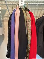 Row of seven blazers/jackets on hangers