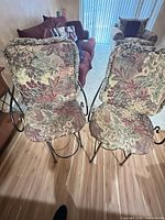 Front view of both metal bar stools with floral cushions