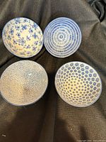 Top view of four patterned bowls showing interior designs