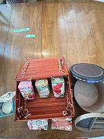 Open NUMI wooden box with soaps, round jewelry organizer and ceramic box visible