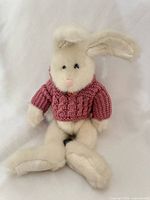 Front view of plush bunny showing sweater and overall appearance