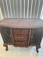 Front view of wicker rattan sideboard showing drawers and cabinet doors