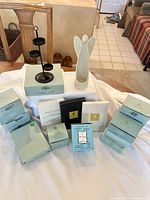 Lot overview with candle tree, porcelain angel, and boxed candles