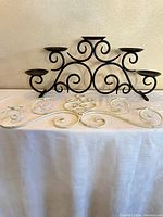 Black tabletop candle stand and white wall rack displayed together