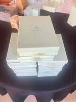 Stacked pastel-green PartyLite candle boxes