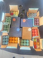 Top view showing all open boxes of tealights, sealed boxes and holder
