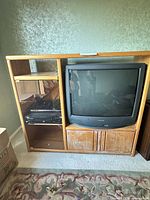 Front view of entertainment stand with CRT bay and shelving