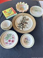 Group view of all dishware laid out on black cloth