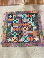 Front view showing patchwork design and overall condition