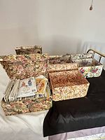 All six decorative boxes opened or stacked, showing patterns and included sewing patterns