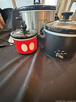 All three slow cookers grouped together showing relative sizes