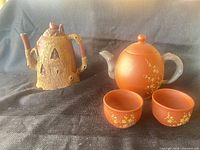 Overview showing both teapots and two cups