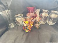 Group shot of all eight glass vases showing variety of styles and colors