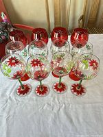 Front view of all twelve holiday wine glasses showing three distinct patterns