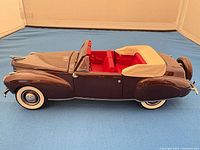Side profile of brown 1941 Lincoln diecast with beige top and whitewall tyres