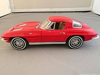 Left side profile of red 1963 Corvette model